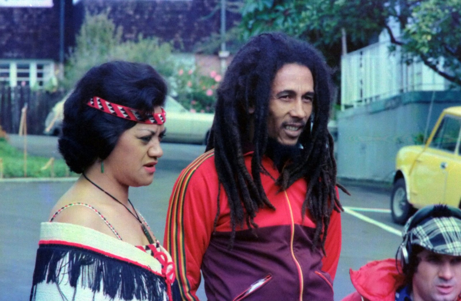 Bob Marley standing beside woman during daytime